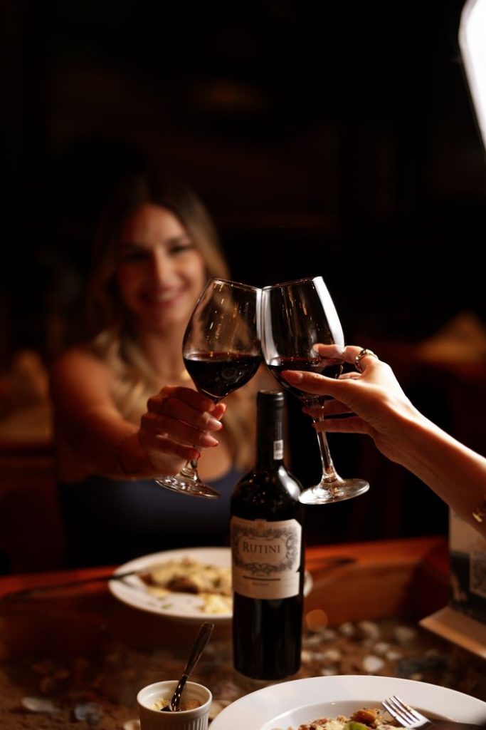 An intimate wine toast in a dimly lit restaurant, perfect for celebrations and gatherings.